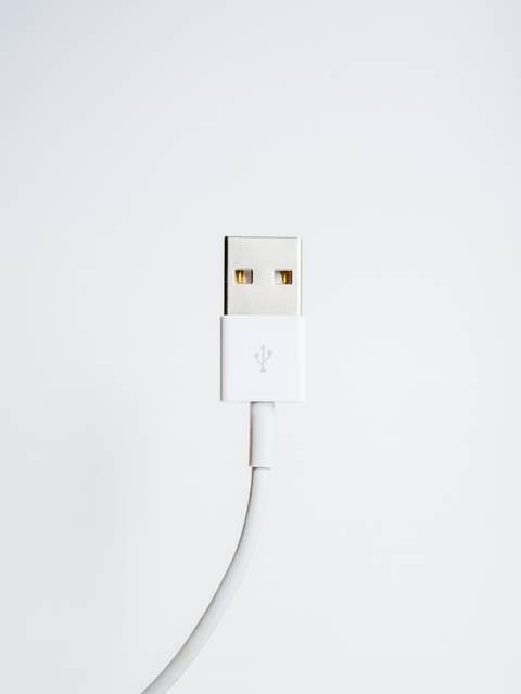 A USB cable with a white connector against a plain white background.