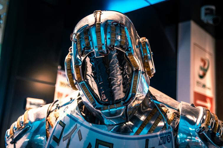 Close-up of a futuristic robot suit with intricate details and blue highlights.